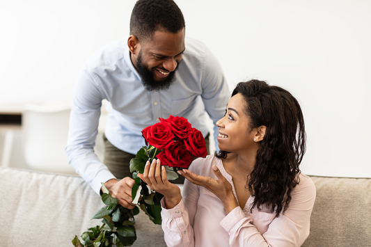 Man giving woman a bouquet of red roses for Valentine's Day
